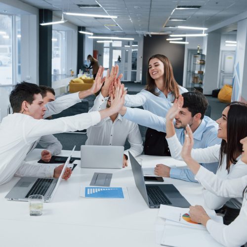 Cheerful business people. Job is done. Group of office workers happy to hit their own records and being successful.